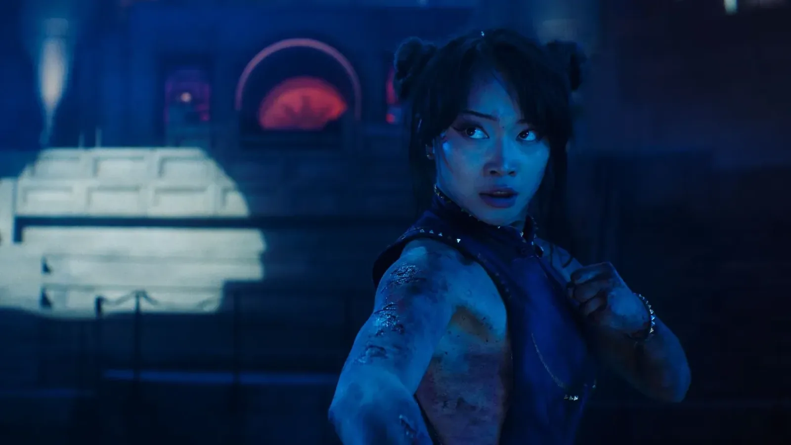 Callina Liang as Chun-Li, washed in blue light, fists up and ready to fight