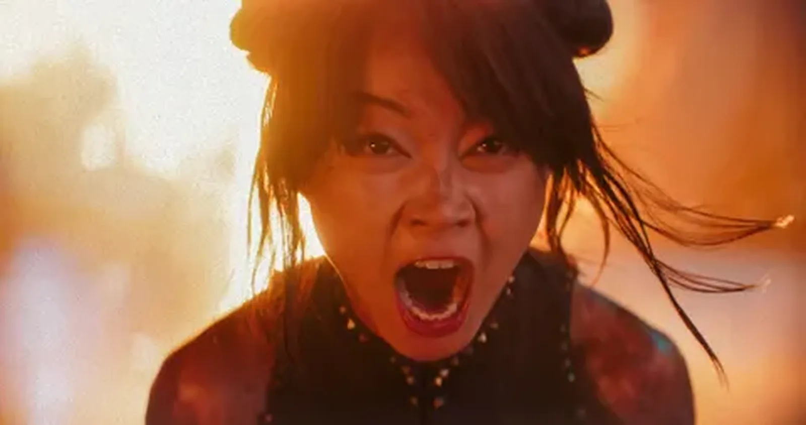 Chun-Li screaming mid-fight, her face lit orange by fire