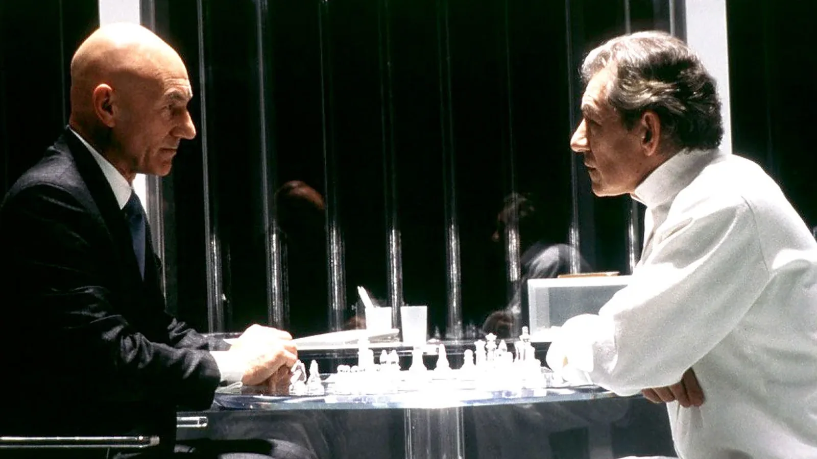 Patrick Stewart as Professor Xavier and Ian McKellen as Magneto playing chess across a glass table in the plastic prison at the end of X-Men